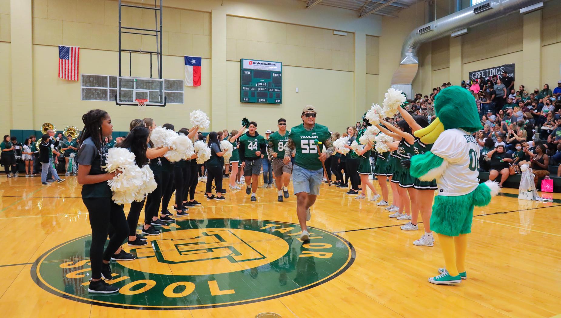 Football Team enters pep rally