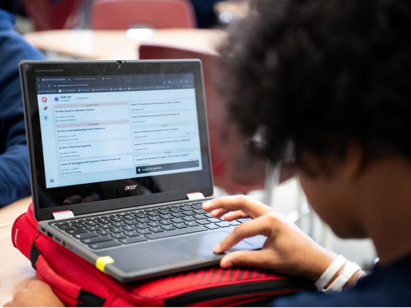 Student working on a laptop during a classroom lesson.