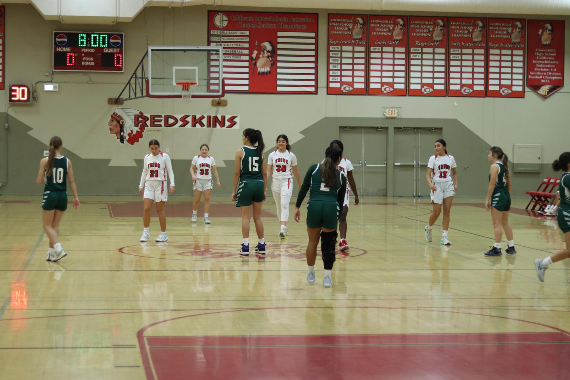varsity girls playing basketball against mariposa