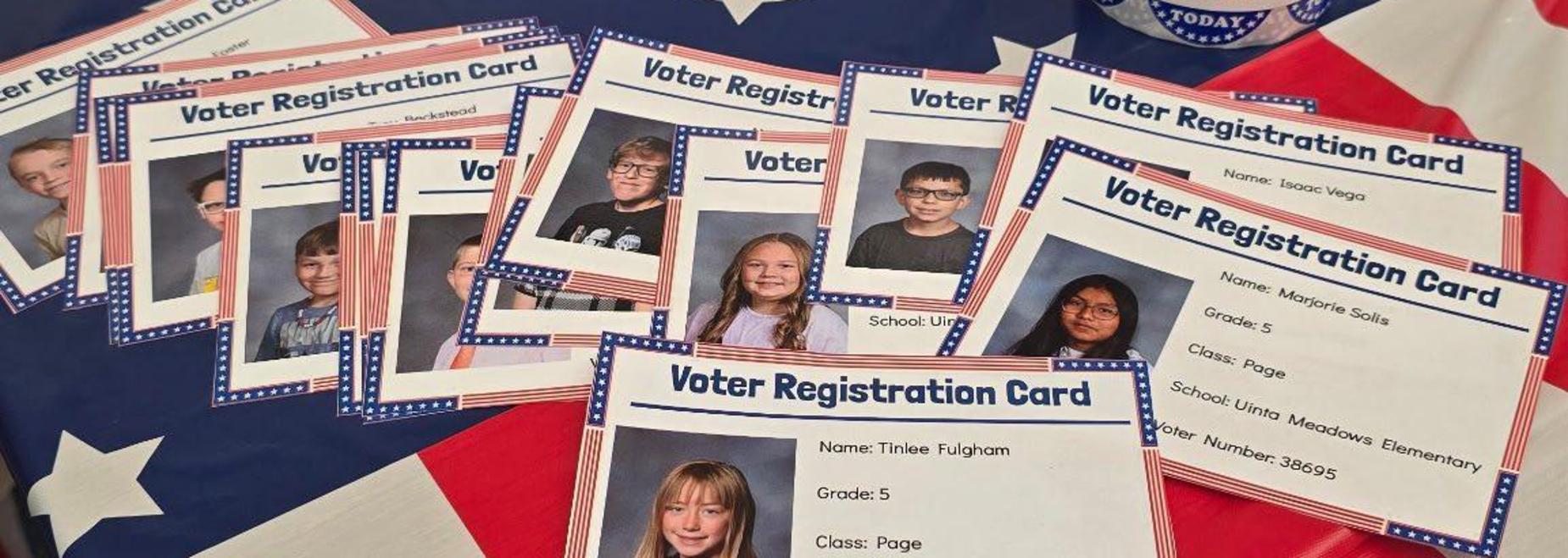 A collection of voter registration cards from different students on a patriotic background.
