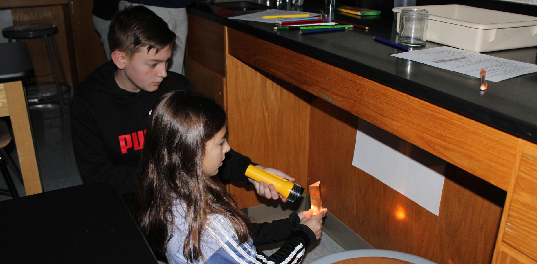 students conducting light-bending experiment