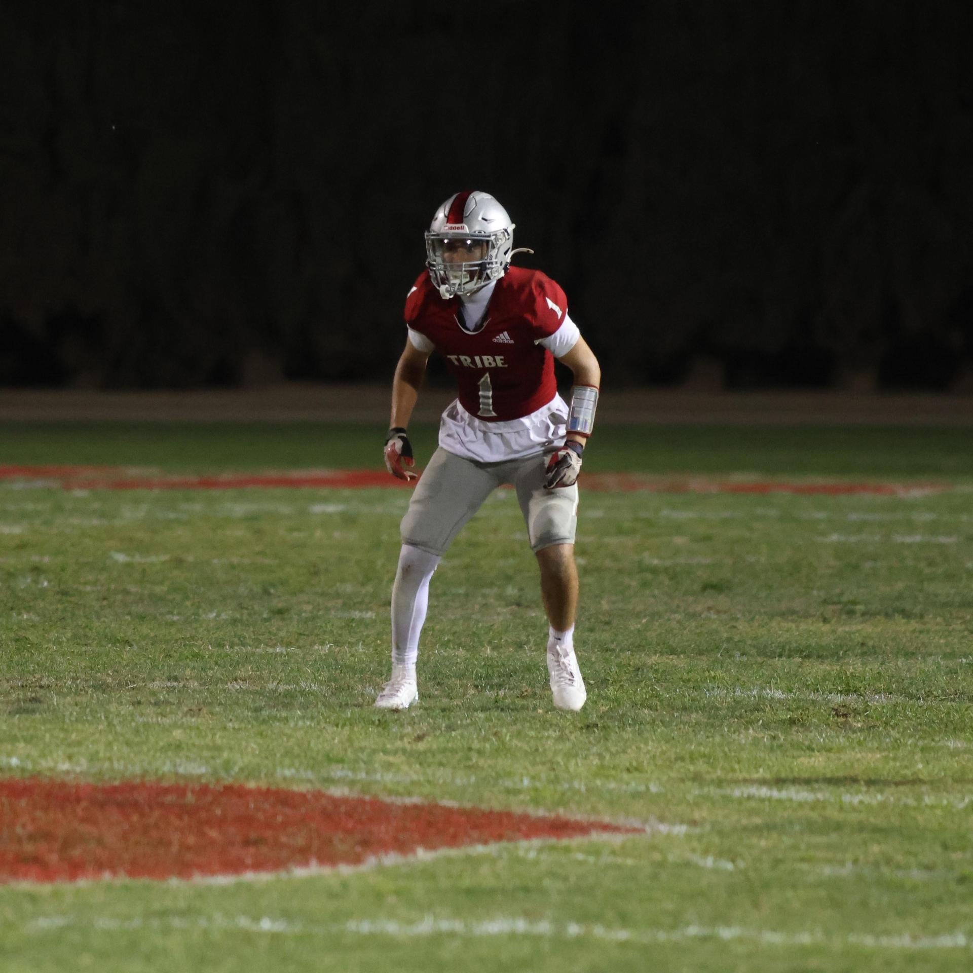 Varsity football players in action against Parlier 141
