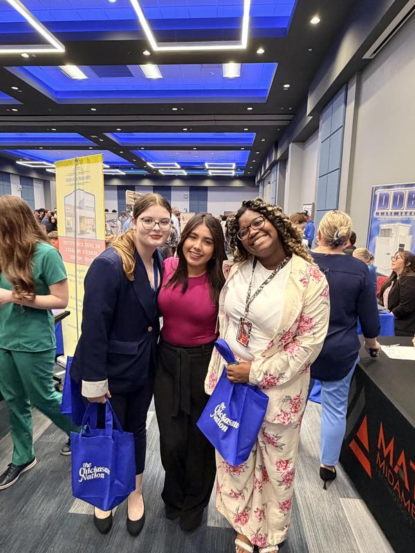 three students posing at career fair