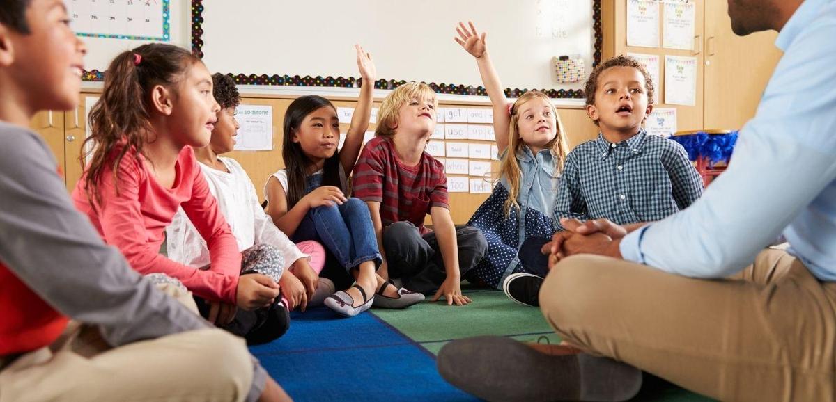  Student raising hands in a classroom