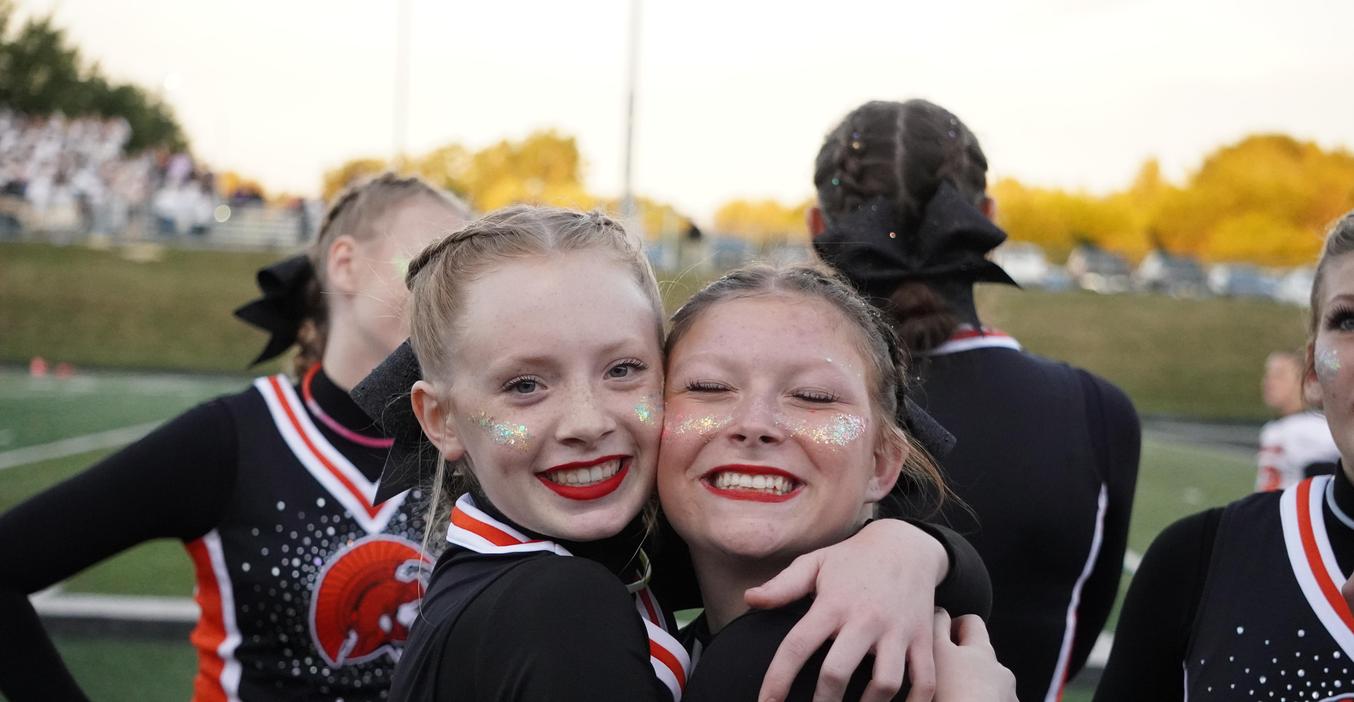 Two cheerleaders are all smiles at the first home football game.