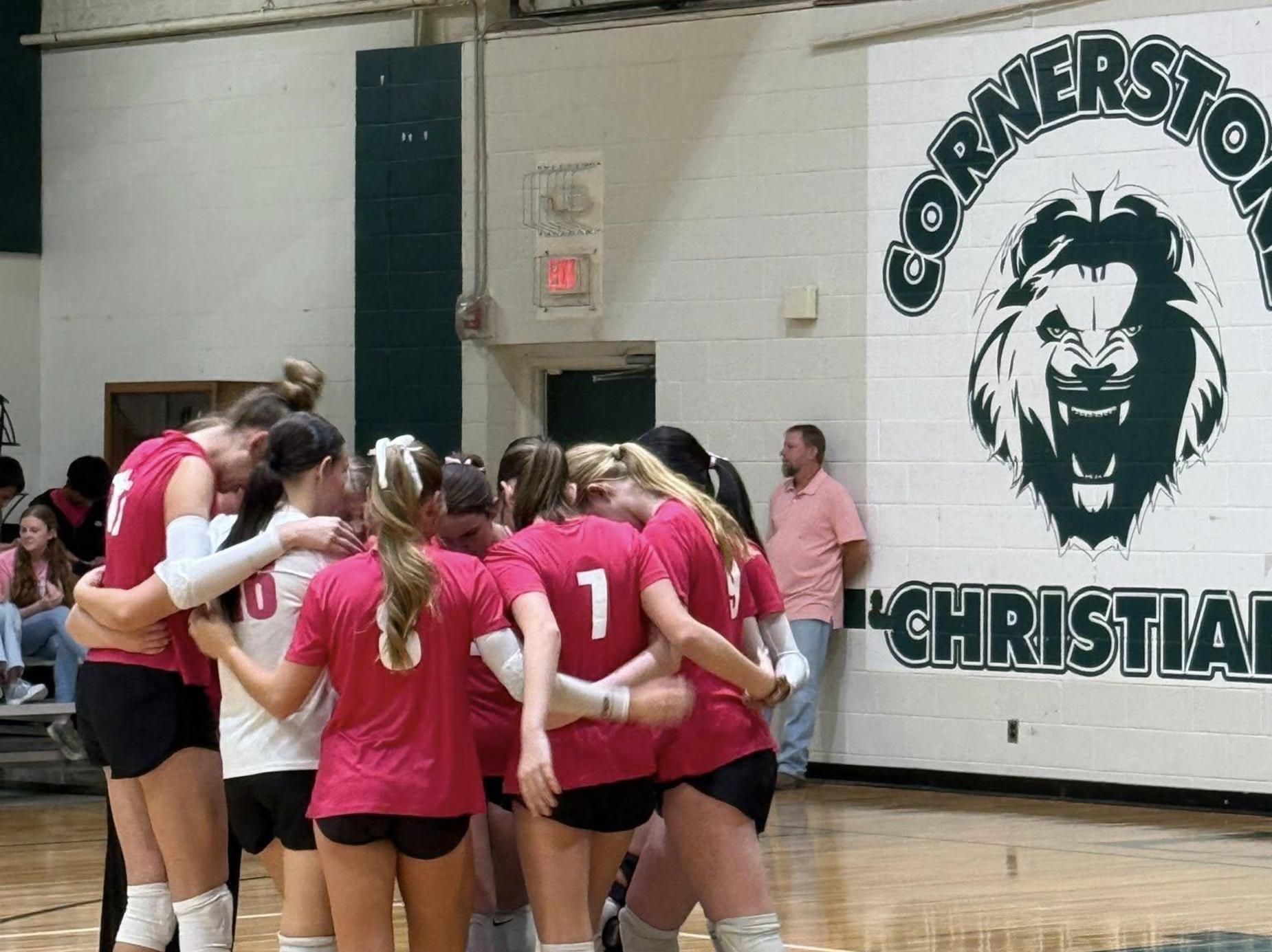 Volleyball players praying