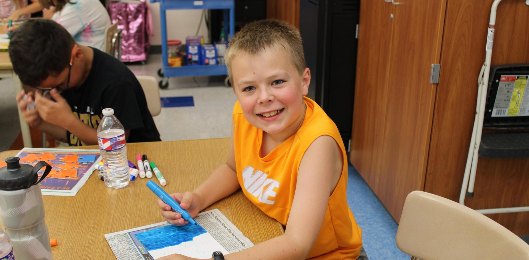 boy coloring with a marker