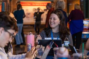 A student speaks with peers