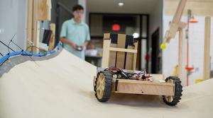 Student guiding a Robot