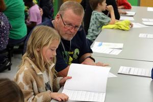 Buchanan Elementary students share writing with adults.