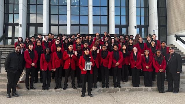Members of the BHS band hold up a plaque