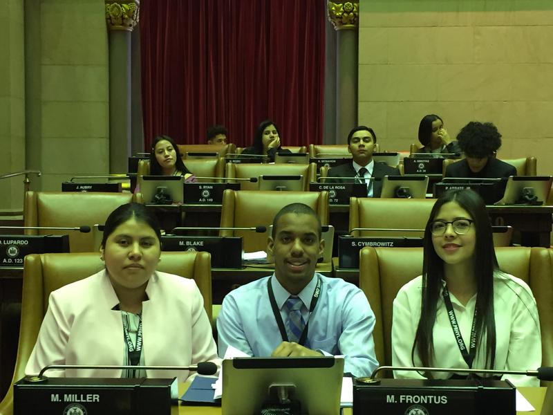 Students sitting in assembly seats.