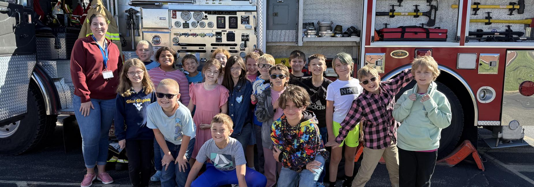 students posing in front of fire truck