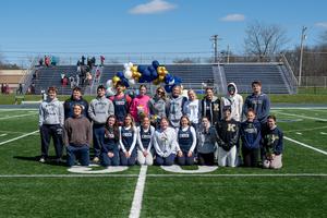 senior members of the track team in front of balloon arch