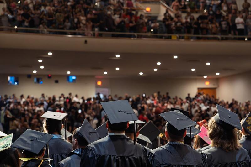 Graduates look out into the crowd
