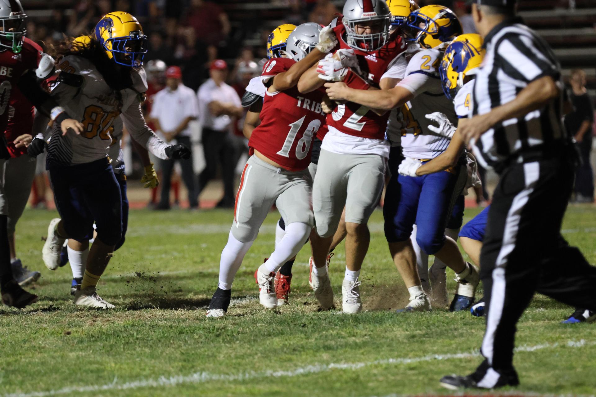 Varsity football players in action against Parlier 117