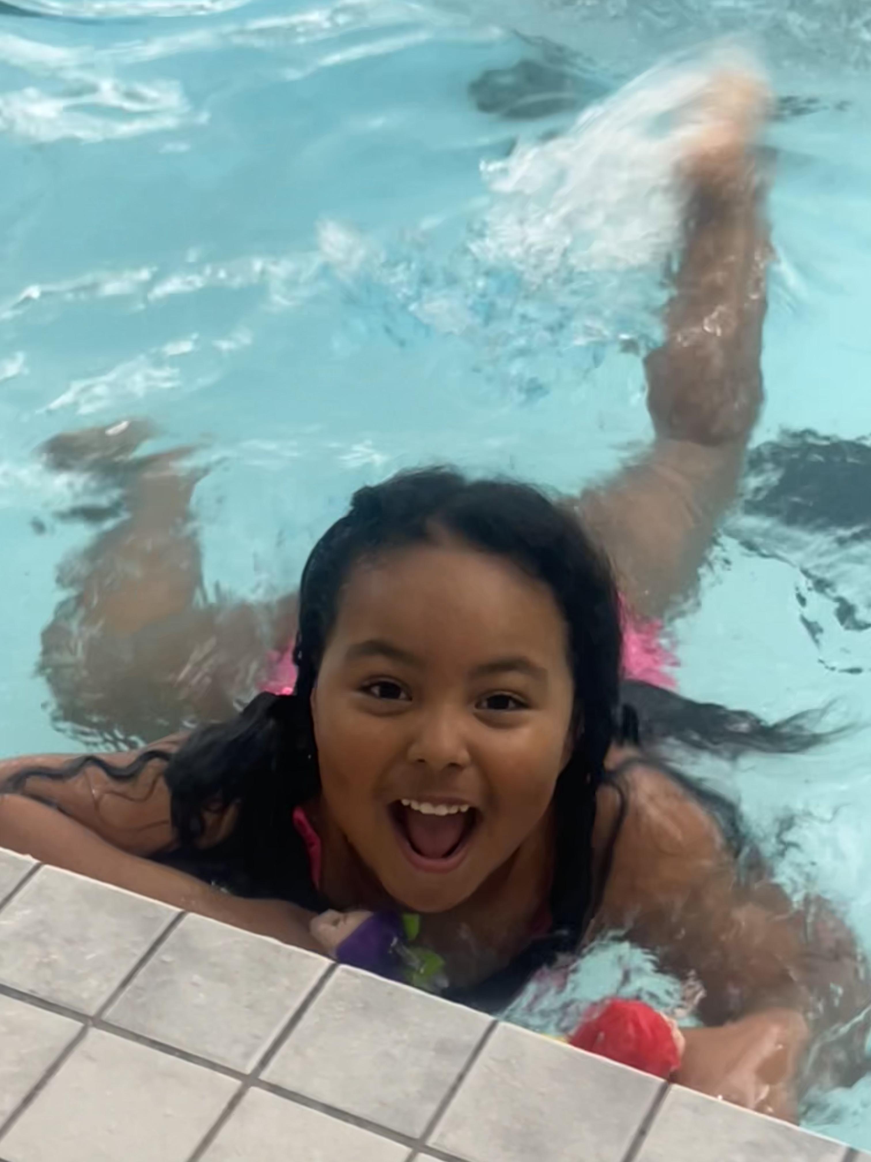 Girl in pool swimming 
