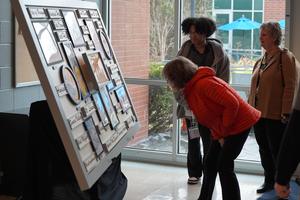 Visitors check out the mural