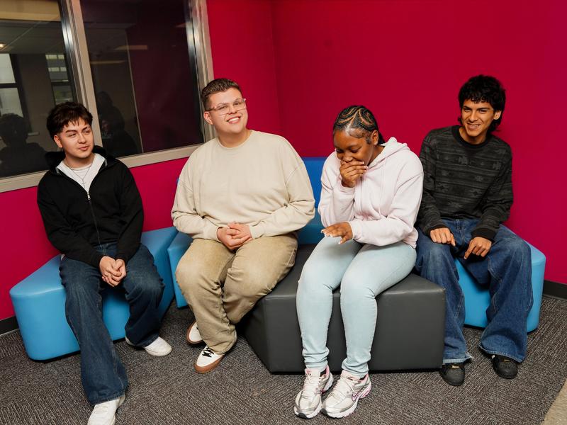 Four students laughing together