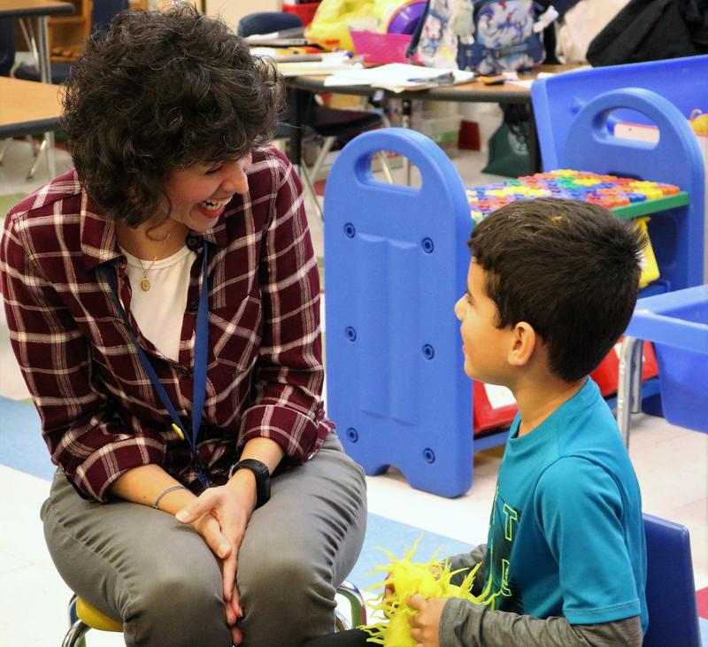 Photo of Lincoln preschool teacher and student exchanging compliments during Week of Respect game.