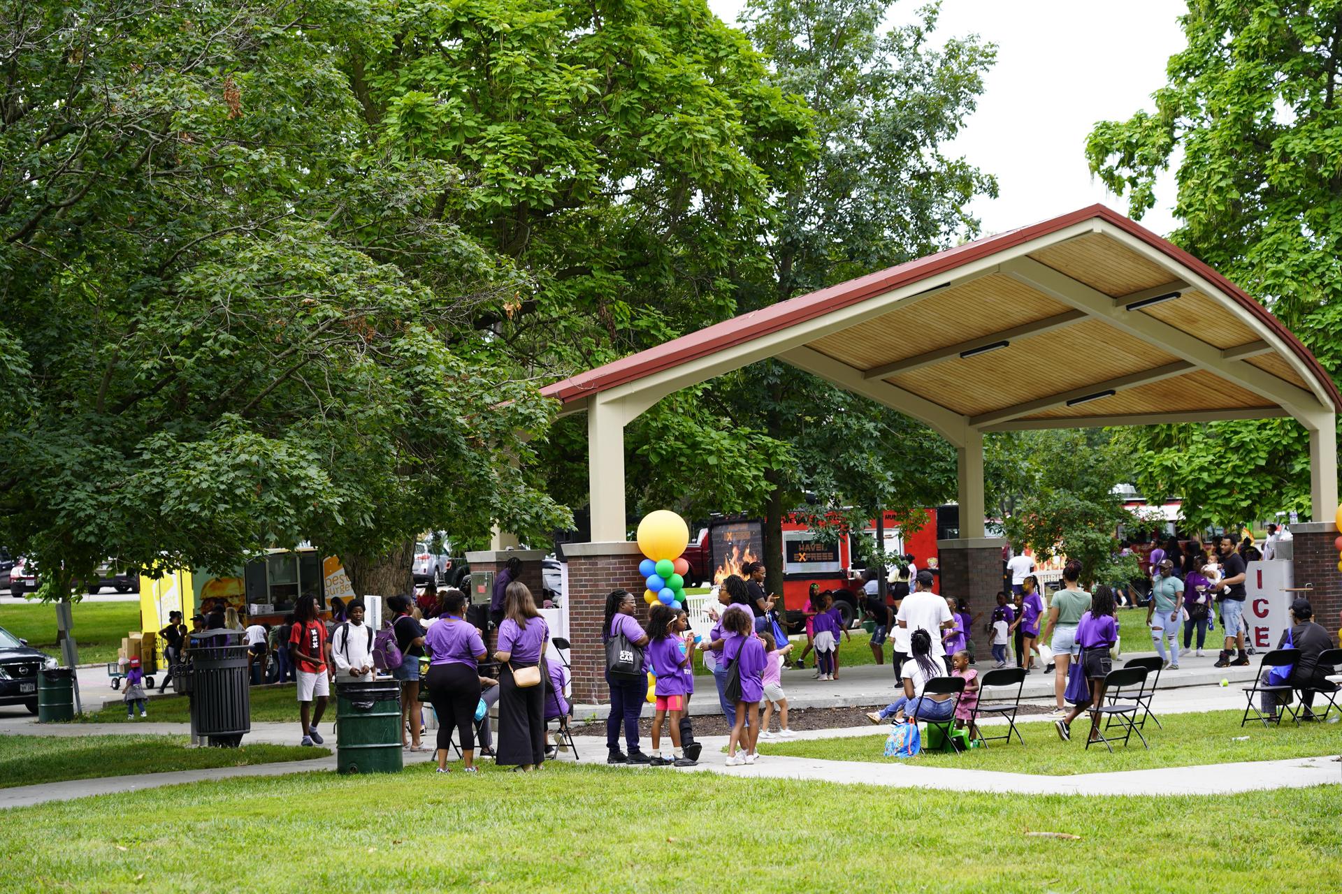Scholars and families gather at the stage at Mandela Fest