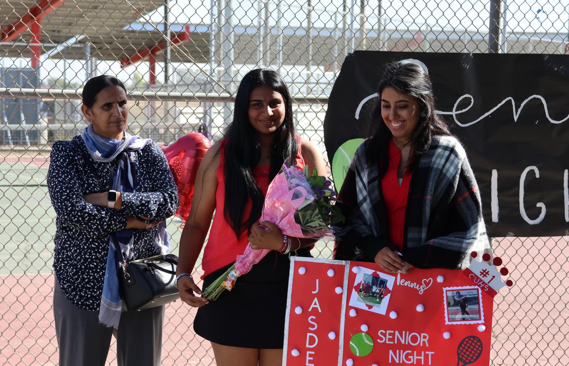 tennis players, family, and staff celebrating senior night