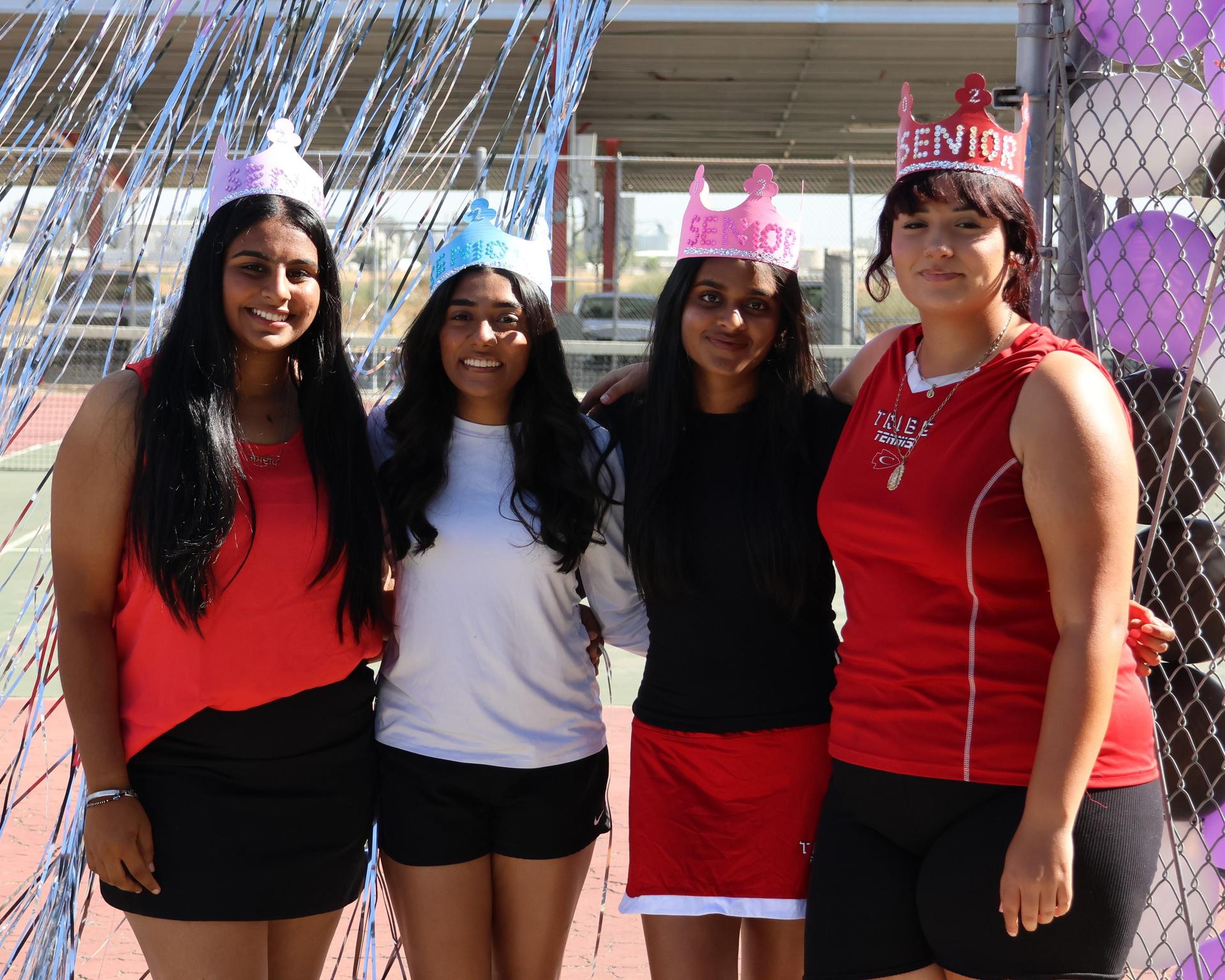 tennis players, family, and staff celebrating senior night