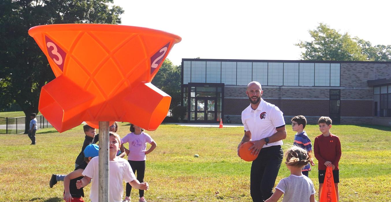 McFall Principal Sleeman plays ball with students on the playground.