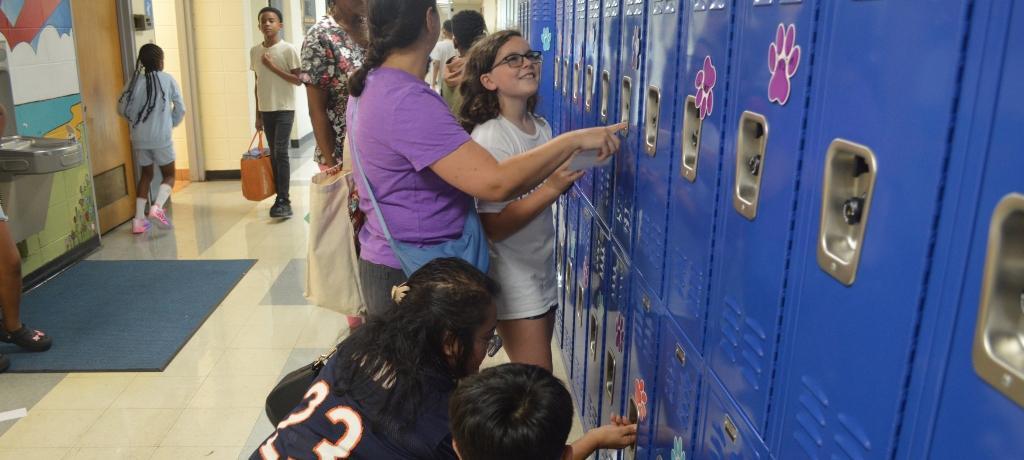 Students and parents practice locker combinations.