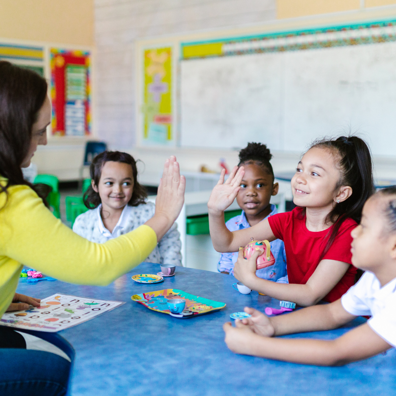 teacher high fiving students