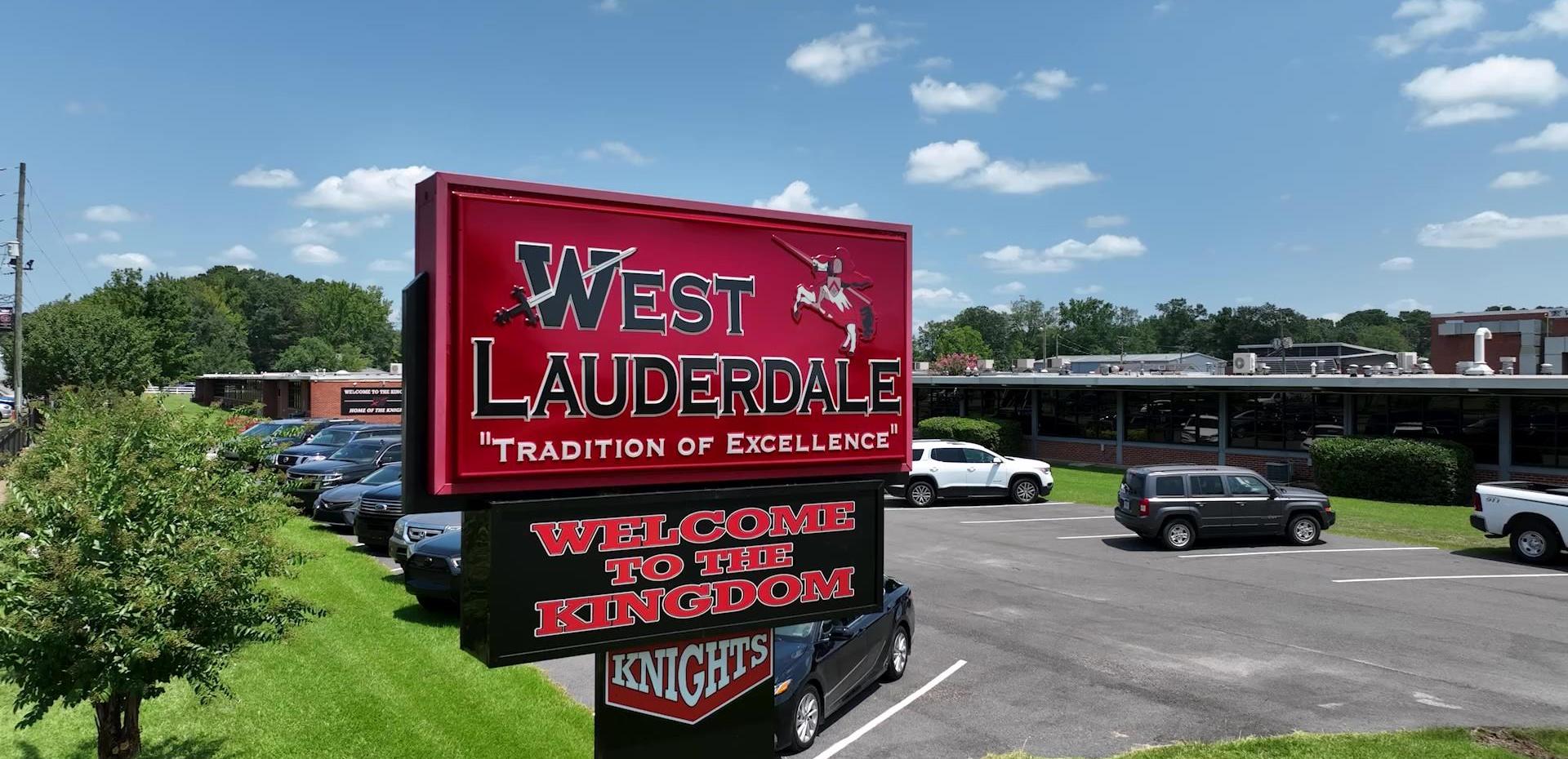 Sign for West Lauderdale with 'Tradition of Excellence' and 'Welcome to the Kingdom' slogan.