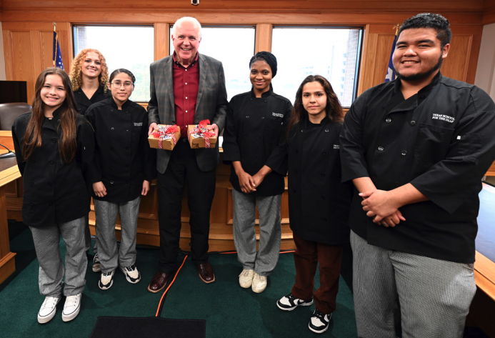 TFC Executive Director Mike Novak stands with a group of six students