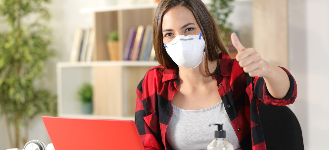 girl wearing mask giving thumbs up