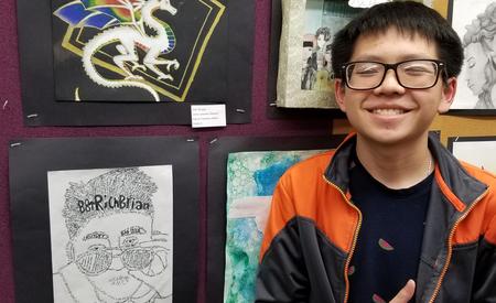 student smiling with artwork