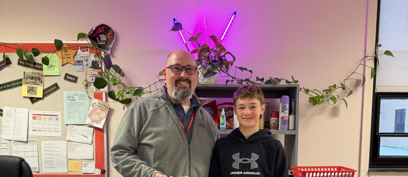 Student spreading joy by passing out treats to teachers.