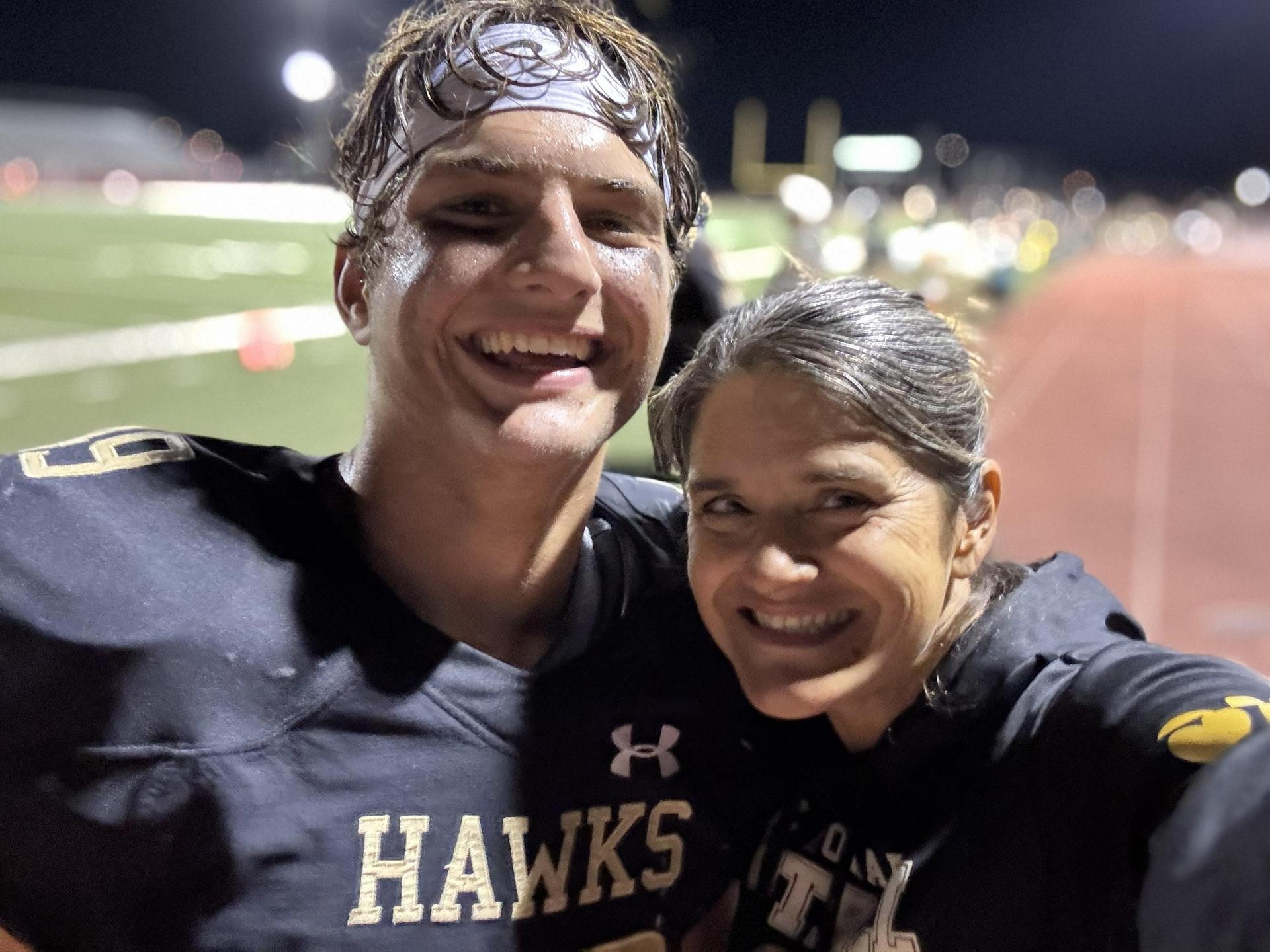 Mrs. Cav & Micah Cav, football sidelines