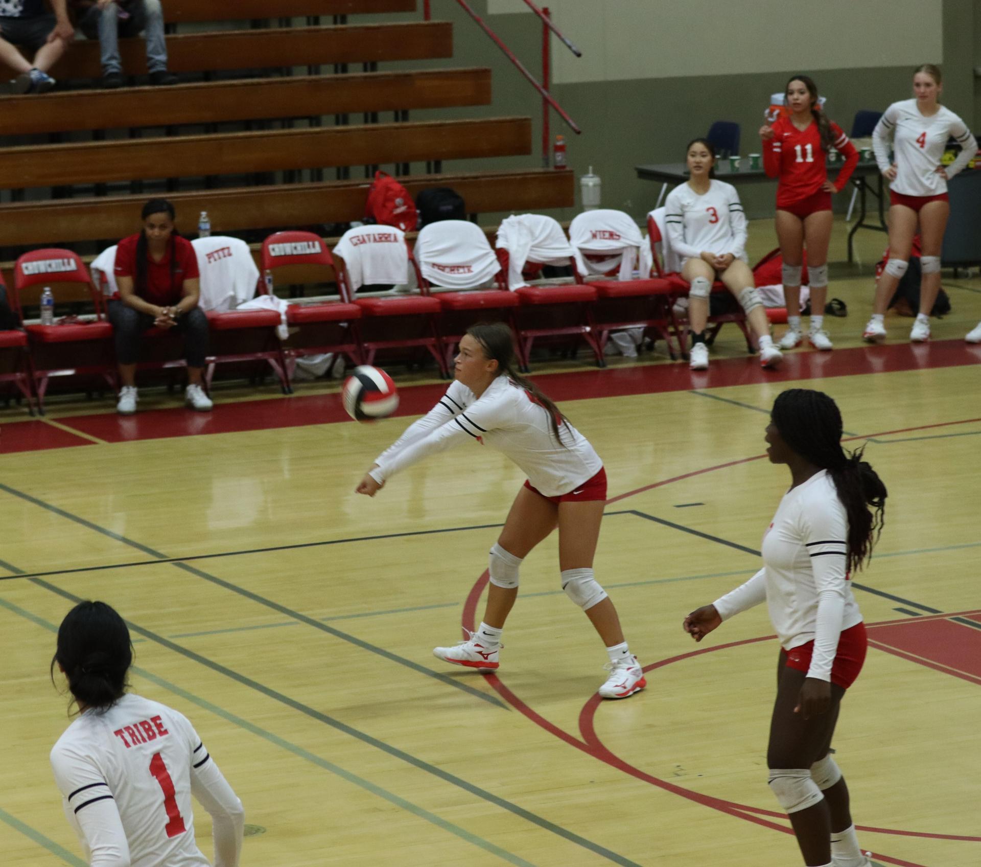 varsity volleyball players in action against liberty