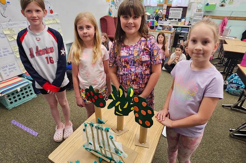 Reagan Houy, Lilly McGuirk, Sammie Younger, and Joy Dixon with their model fence windbreak