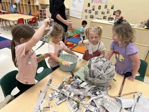 In Prek students read “Hooray, A Piñata!” over the last few weeks so we made a paper mache piñata, filled it, discussed and figured out how to hang and fill it, then smashed it open for Halloween.