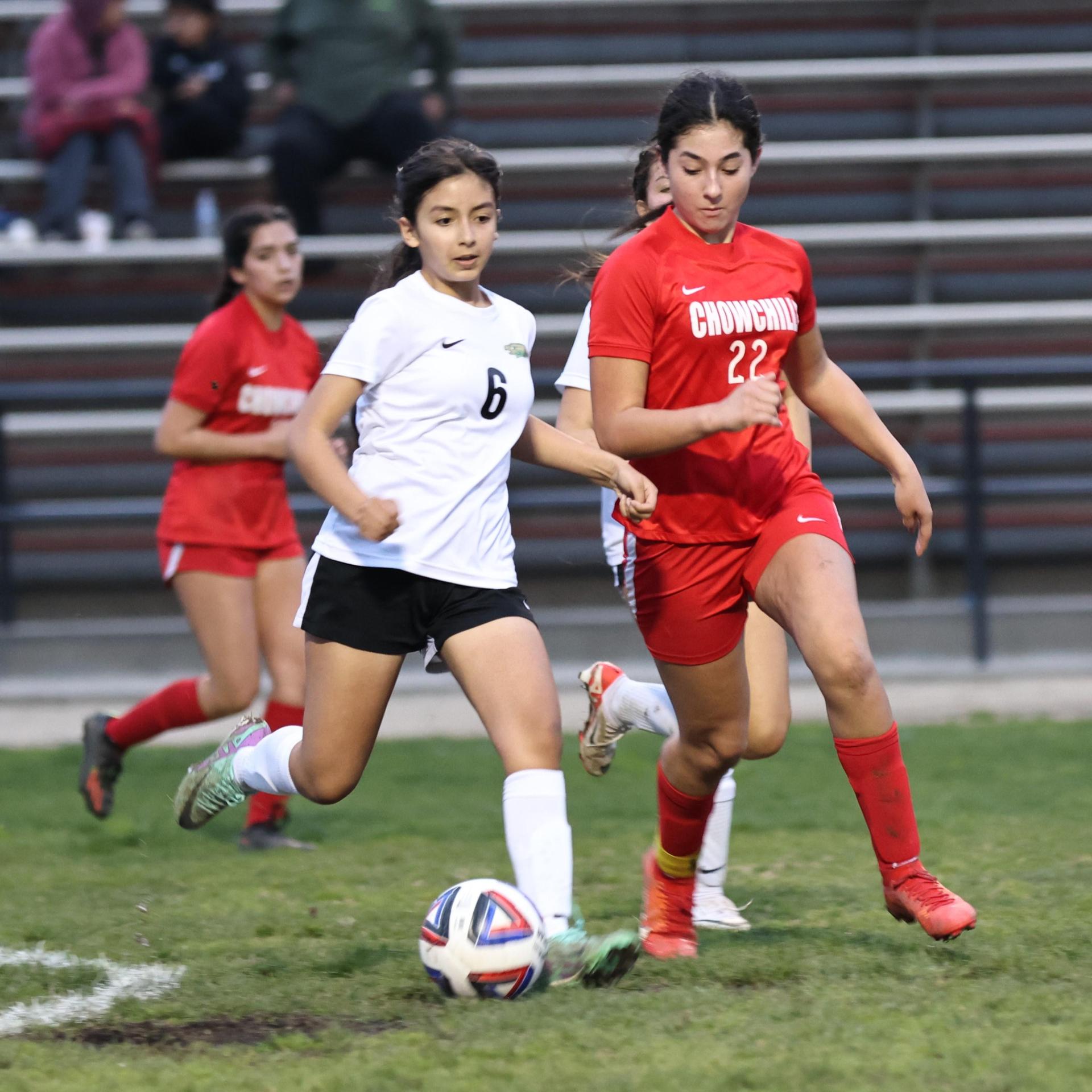 Junior varsity girls playing soccer against liberty