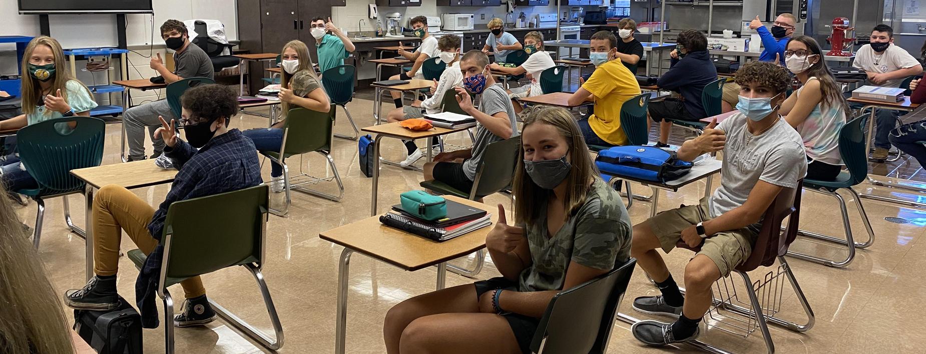 High school students are happy to be back, everyone is giving a thumbs up!