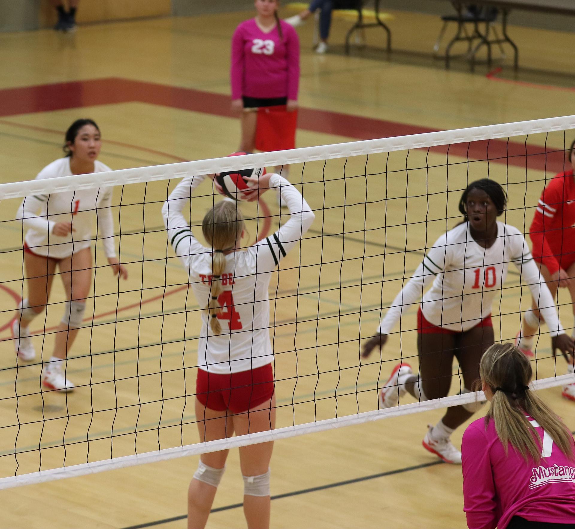 varsity volleyball players in action against Minarets