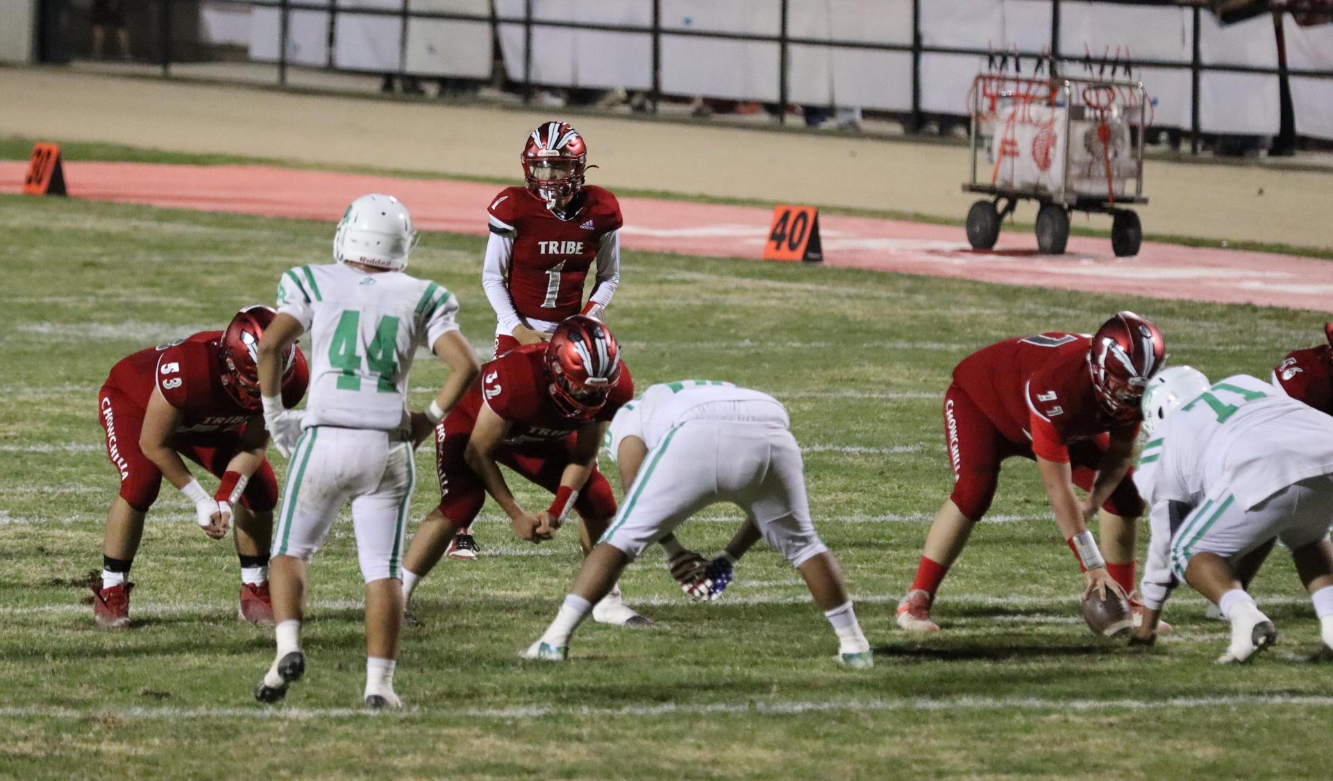 varsity football players in action against Riverdale