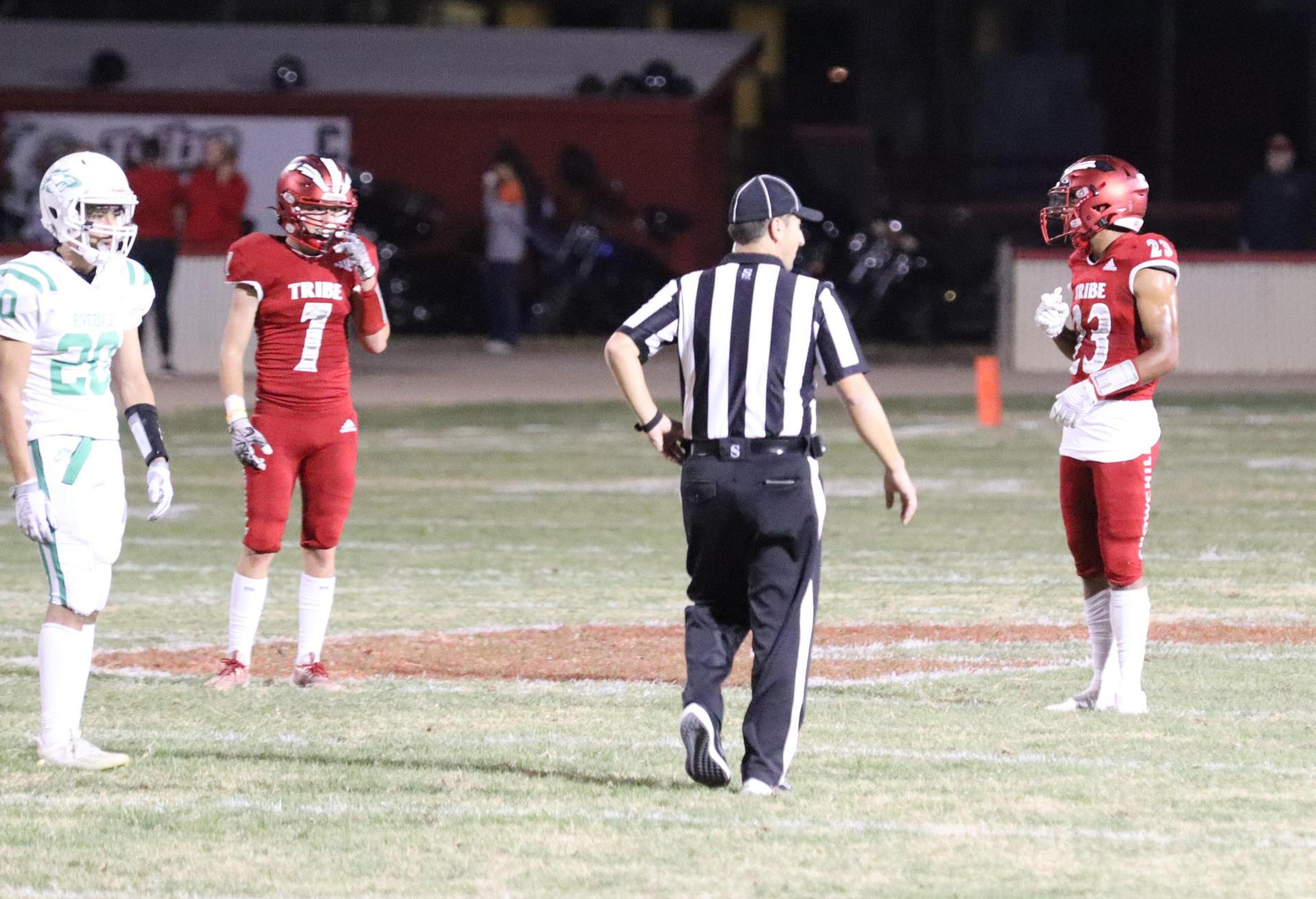 varsity football players in action against Riverdale