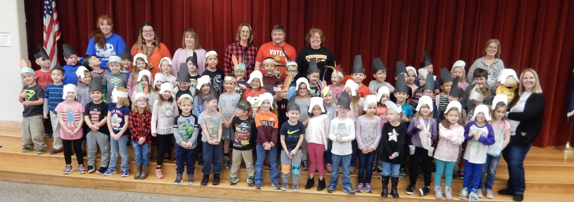Kindergarten students dressed as pilgrims and native Americans for an early Thanksgiving feast