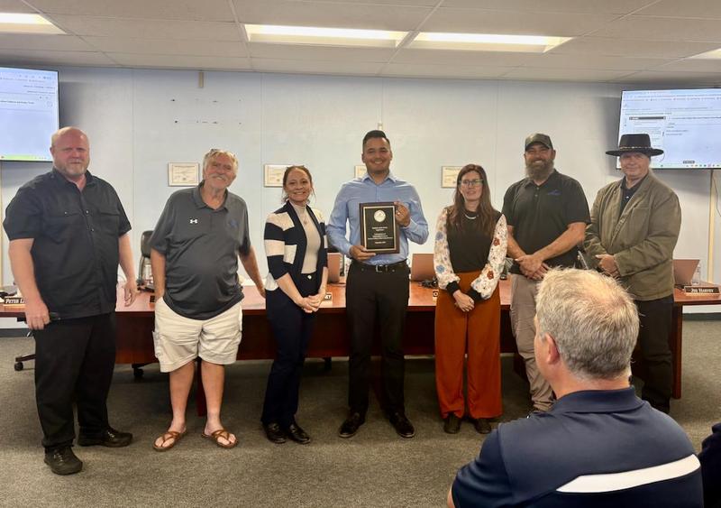 The school board presents Employee of the Month awards.