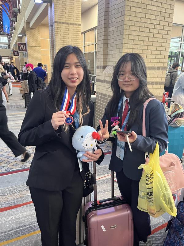 Smiling teens dressed in professional attire