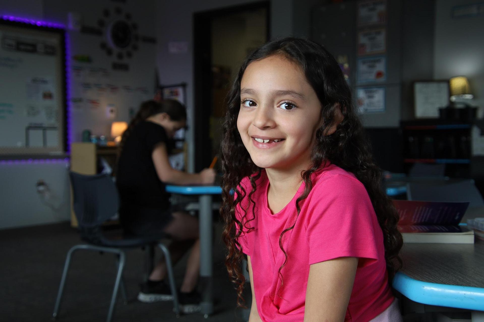 Student smiling in a classroom