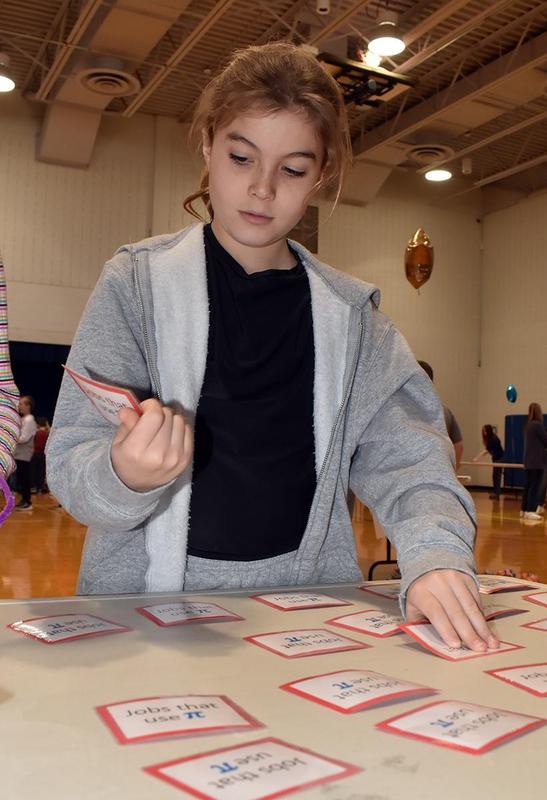 a girls flipping over cards in a memory game