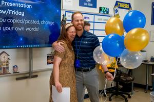 jon sides and carol sides hugging during surprise